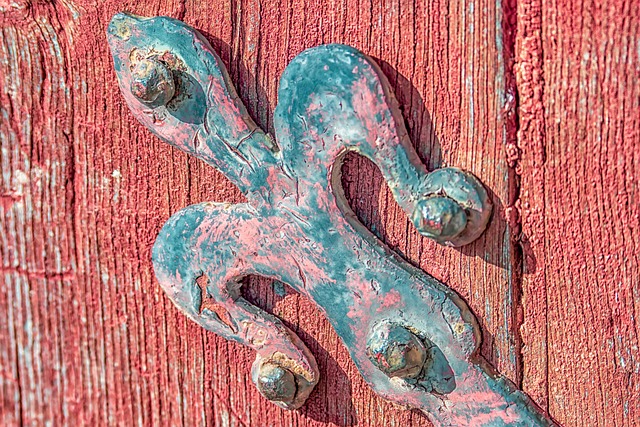 Ceramic bowl of hand-harvested fleur de sel sea salt crystals from Guerande Brittany France with delicate moist texture, photographed on a driftwood board by the coast
